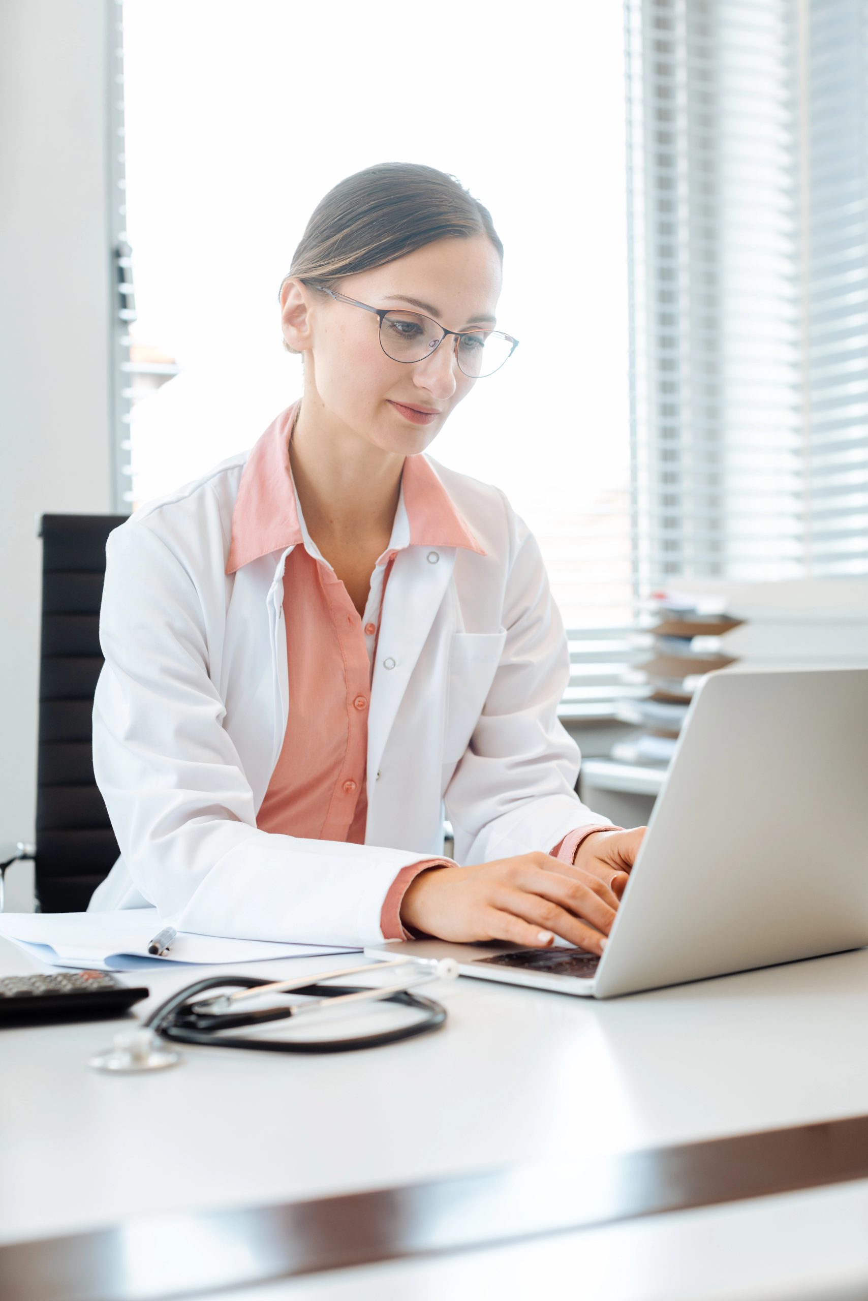 Photo of a female doctor at a computer.